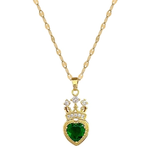 Luxurious gold crown necklace featuring a green heart-shaped crystal pendant on a gold chain