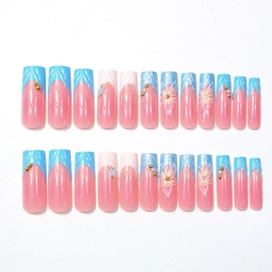 French press-on nails with 3D floral patterns, blue tips and pearls ballerina shape