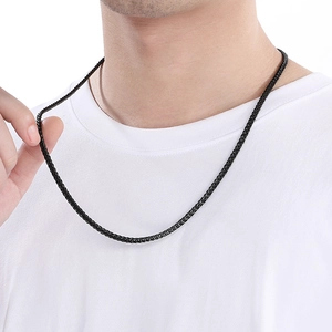 Detail showing the flexibility of a black matte stainless steel wheat chain necklace