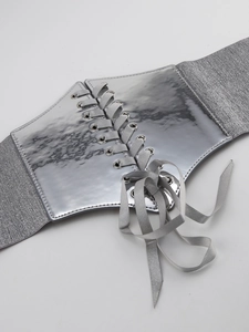 Detail of silver corset belt showing metallic front panel and elastic glitter fabric band