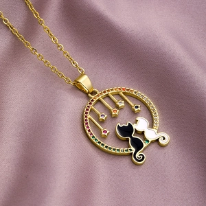 Cat pendant necklace with gold ring, zircon stones and stars on purple silk background