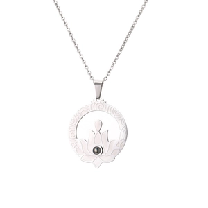 Macro detail of silver stainless steel lotus pendant with black projection stone