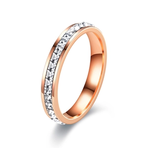 Macro detail of eternity band ring featuring square-cut zircon stones in rose gold finish