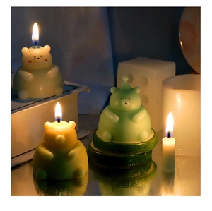 Detailed view of 3D bear-shaped scented candles in pastel yellow, green and orange colors