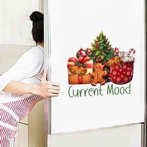 Close-up of Christmas stickers with tree and gingerbread man on a kitchen fridge
