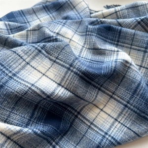 Close-up of blue and white checkered plaid scarf showing soft faux cashmere fabric texture