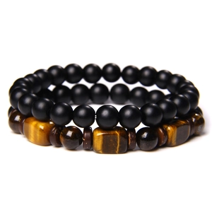 Detail of beaded bracelet set with tiger eye squares, matte black beads and stone textures
