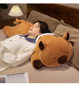 Cozy room scene showing a woman sleeping with a soft giant Capybara plush pillow