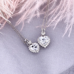 Close-up of heart-shaped S925 silver pendant necklace with clear halo moissanite