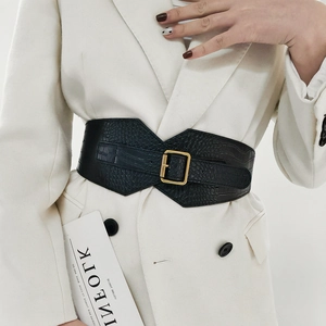 Detail showing the crocodile texture and gold square buckle on a black wide belt