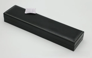 Detail of black PU leather watch box featuring white contrast stitching and sleek texture