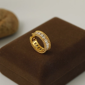 Macro detail of luxury gold ring featuring rectangular gemstones on velvet box