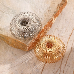 Minimalist spring metal bracelet in gold and silver finish on natural stones
