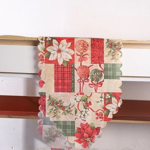 Détail de la bordure festonnée du chemin de table de Noël avec poinsettia et motif écossais