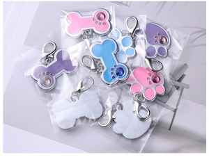 Bulk set of bone and paw shaped zinc alloy pet ID tags with enamel finish and rhinestones
