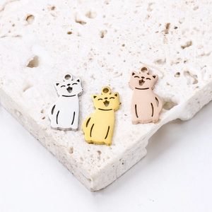 Macro view of cat-shaped stainless steel pendants in silver, gold, and rose gold finish