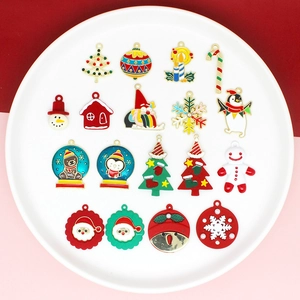 Detailed flat lay of festive Christmas alloy charms including Santa, snowmen and snowflakes