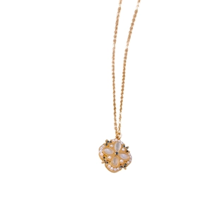 Elegant gold flower necklace with white petals and pearls on a white background