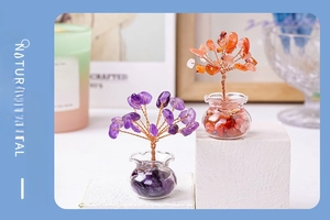 Macro detail of handmade purple and orange natural crystal trees on white stone base