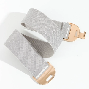 Detailed view of grey elastic woven belt with modern gold geometric buckle on white background