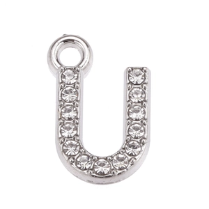 Detailed macro view of silver U-shaped pendant with sparkling clear rhinestones