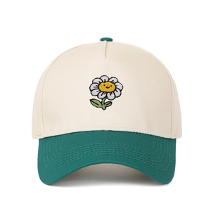 Close-up of smile sunflower embroidery on beige and green patchwork baseball cap