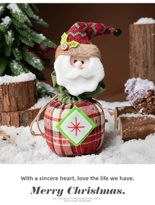 Detailed embroidery and plush fabric texture on a Santa themed drawstring gift bag