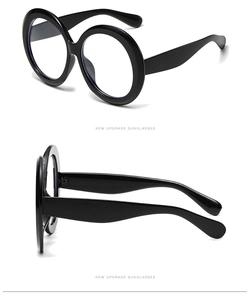 Detail view of black oversized round glasses frames with a stylish polished finish