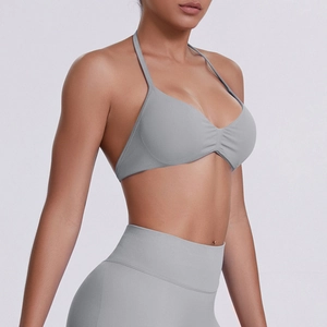 Detail of gray seamless halter-neck sports bra with V-neck and ruched fabric design
