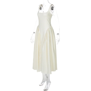 Detailed view of the yellow plaid print fabric and pleated A-line hem of the dress