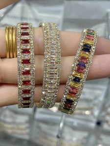 Elegant gold open bracelets with colorful cubic zirconia in red and multicolored stones