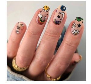 Close-up of matte press-on nails with rainbow, sun, and daisy graffiti art patterns