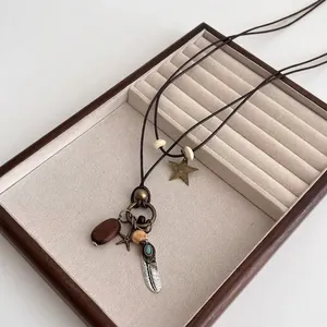 Vintage bohemian long necklace with star, feather and turquoise pendants on leather cord
