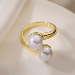 Elegant 18K gold plated bypass open ring with dual pearls and a polished metallic finish