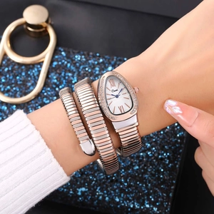 Detail of snake-style wrap watch with silver teardrop dial and two-tone metal band