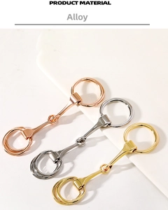 Detailed view of horsebit scarf rings in gold, silver and rose gold alloy finishes
