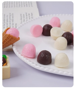 Macro view of realistic 2cm miniature chocolate balls in various colors for DIY crafts