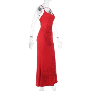 Detail of red slim fit maxi dress featuring intricate black floral sequins and embroidery