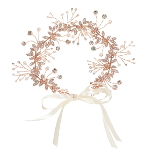 Detail of rose gold bridal belt with pearls, rhinestones, and white satin ribbon