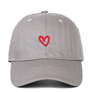 Close-up of a grey cotton baseball cap featuring detailed red heart embroidery on front