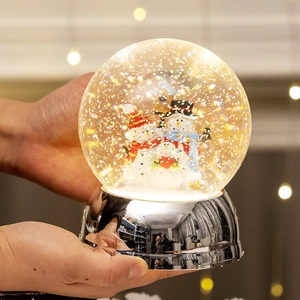 Luminous Christmas snowman water globe with silver base and warm holiday light effects