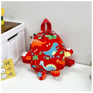 Detail of red kids backpack showing colorful cartoon dinosaurs and 3D fin decorations