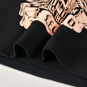 Detail of black cropped hoodie showing vintage print and cotton fabric texture