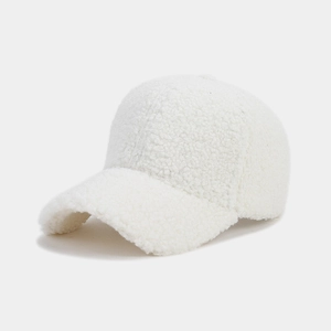 Close-up of thick white faux lamb wool fabric texture on a warm winter baseball cap