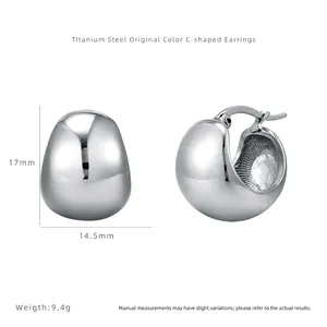 Close-up of silver geometric C-shape titanium steel hoop earrings with size dimensions