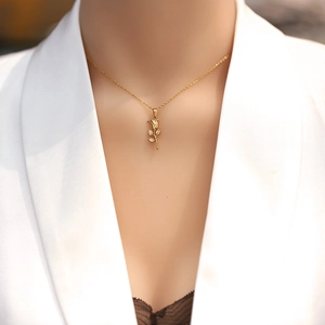 Elegant 18K gold-plated stainless steel rose pendant necklace worn on a female model