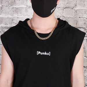 Street style view of a silver and gold bicolor NK chain necklace worn with a black hoodie