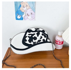 Detail of creative cowboy hat shaped crossbody bag with cow print and star detail