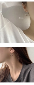 Detail view of 23mm S925 sterling silver hoop earrings shown on model with measurements