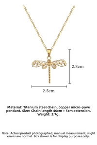 Close-up of golden dragonfly pendant with white zircons and hollow wing textures